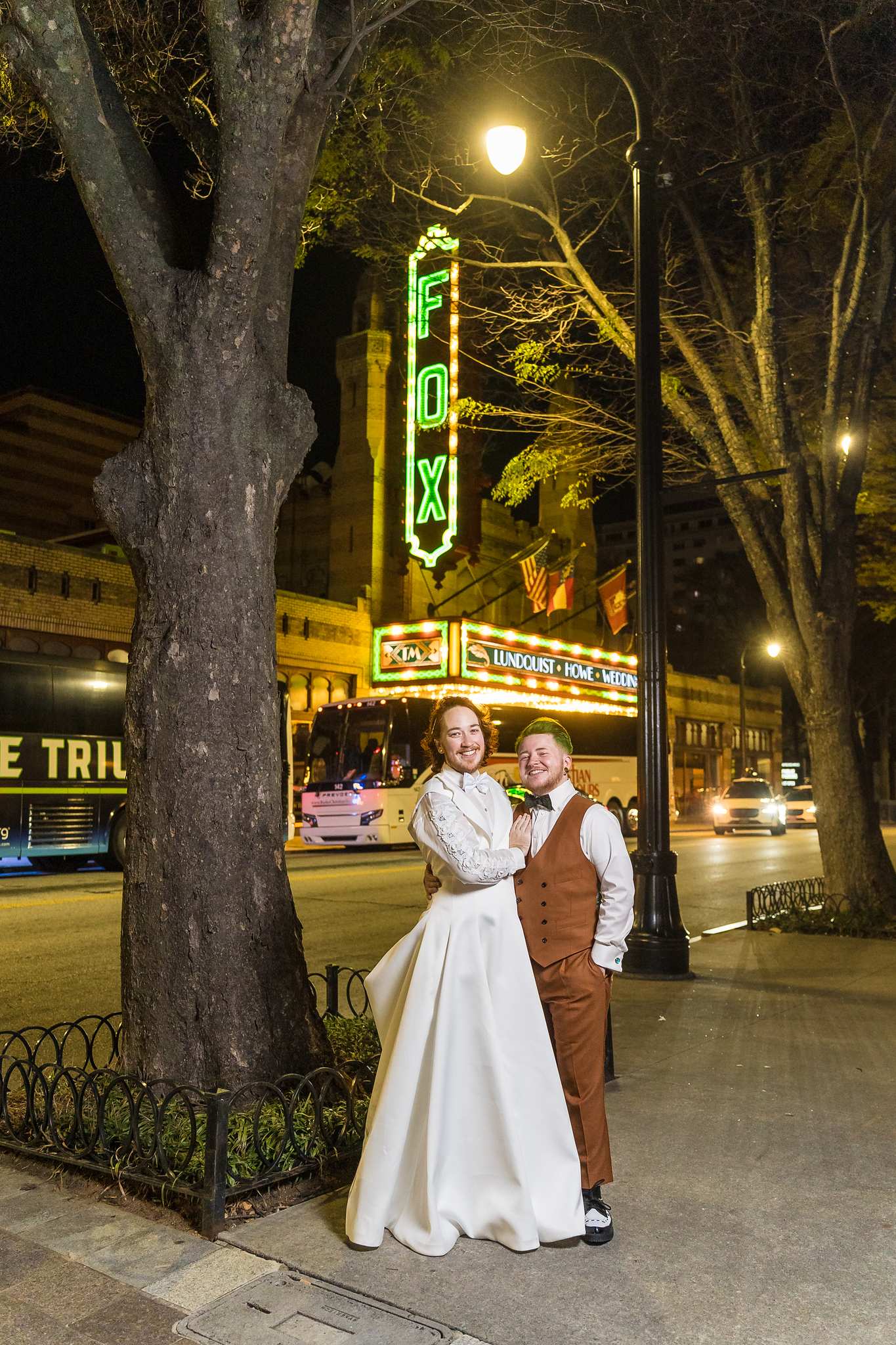 Couple under the Fox Theatre sign and streetlights at night