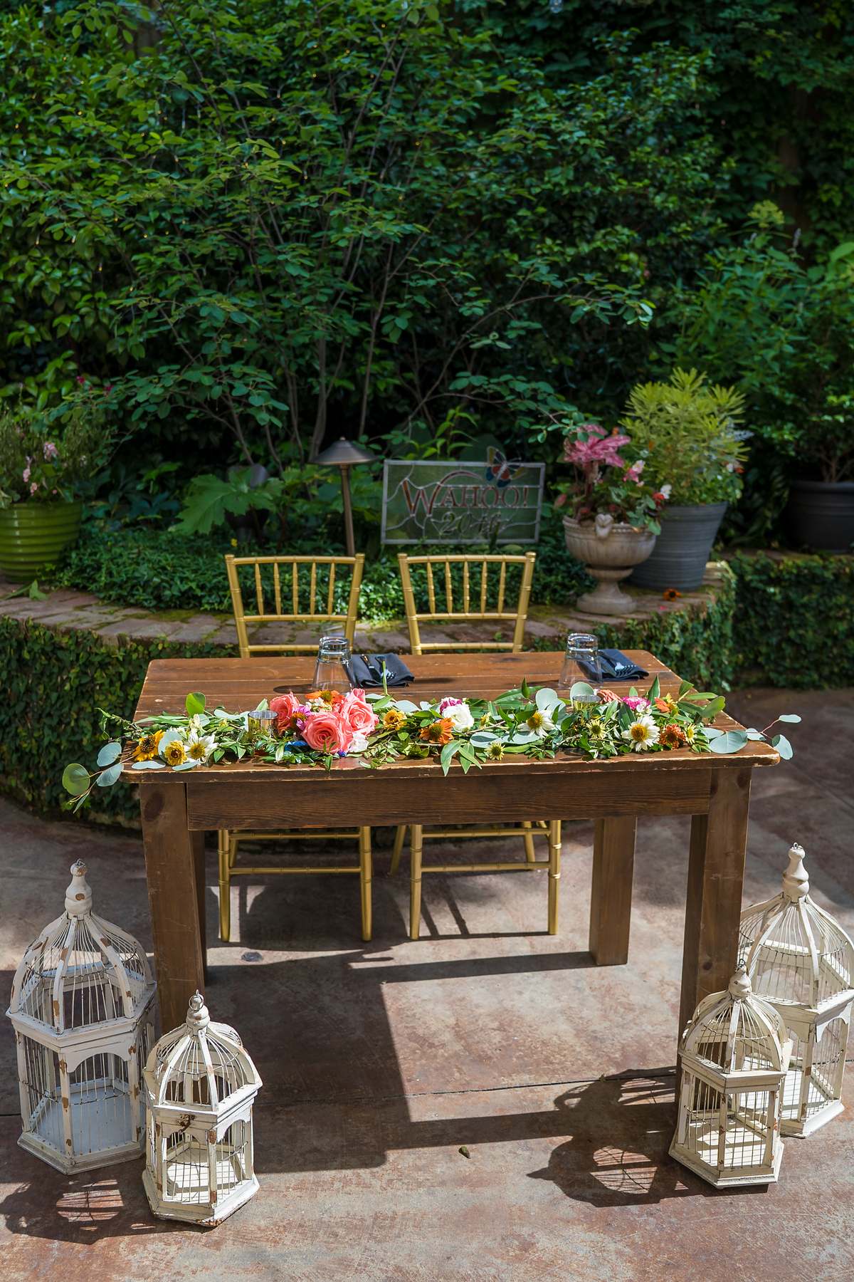 Sweetheart table with colorful flowers in the Wahoo! Grill garden