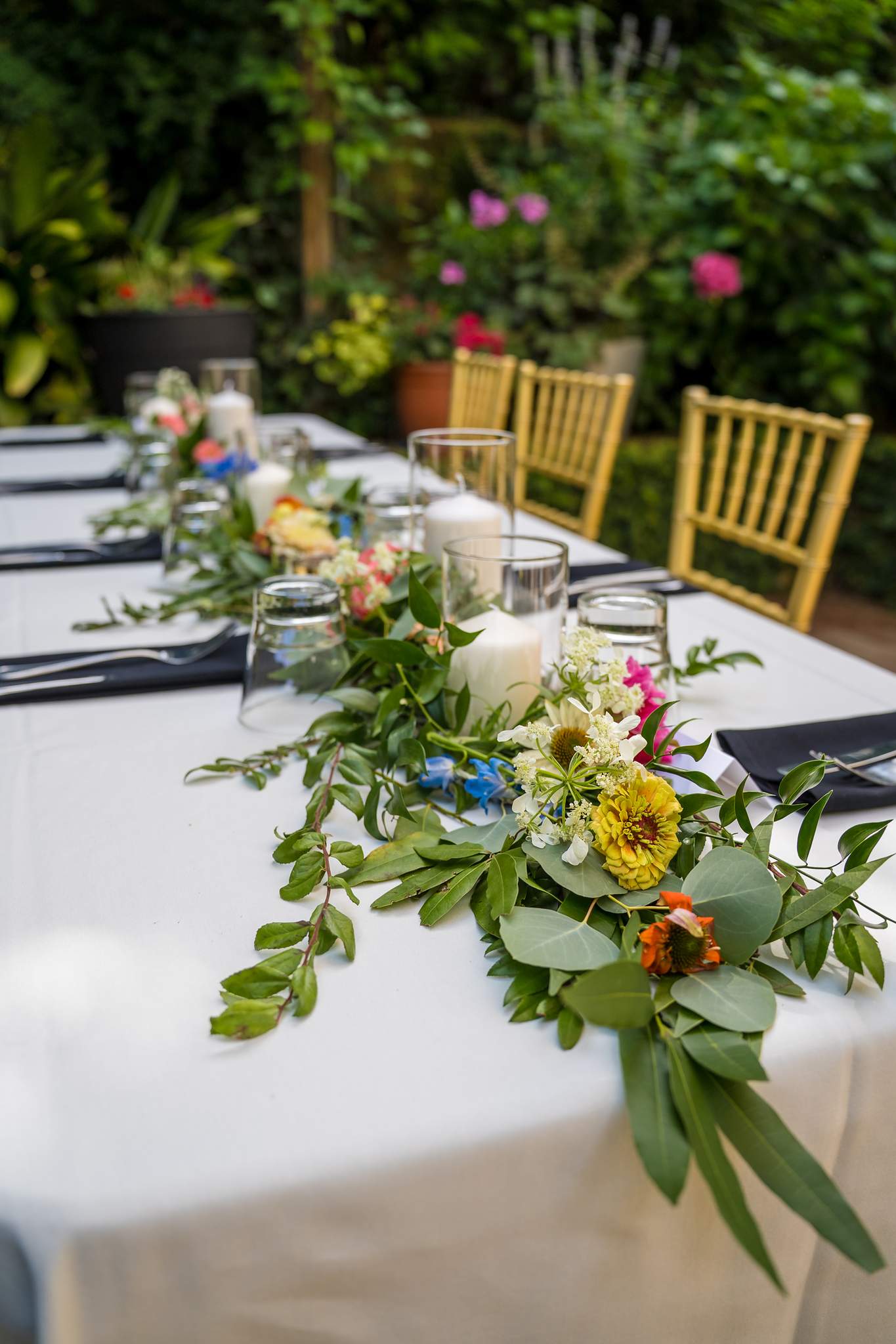 Floral table garland on a reception table in the garden at Wahoo! Grill