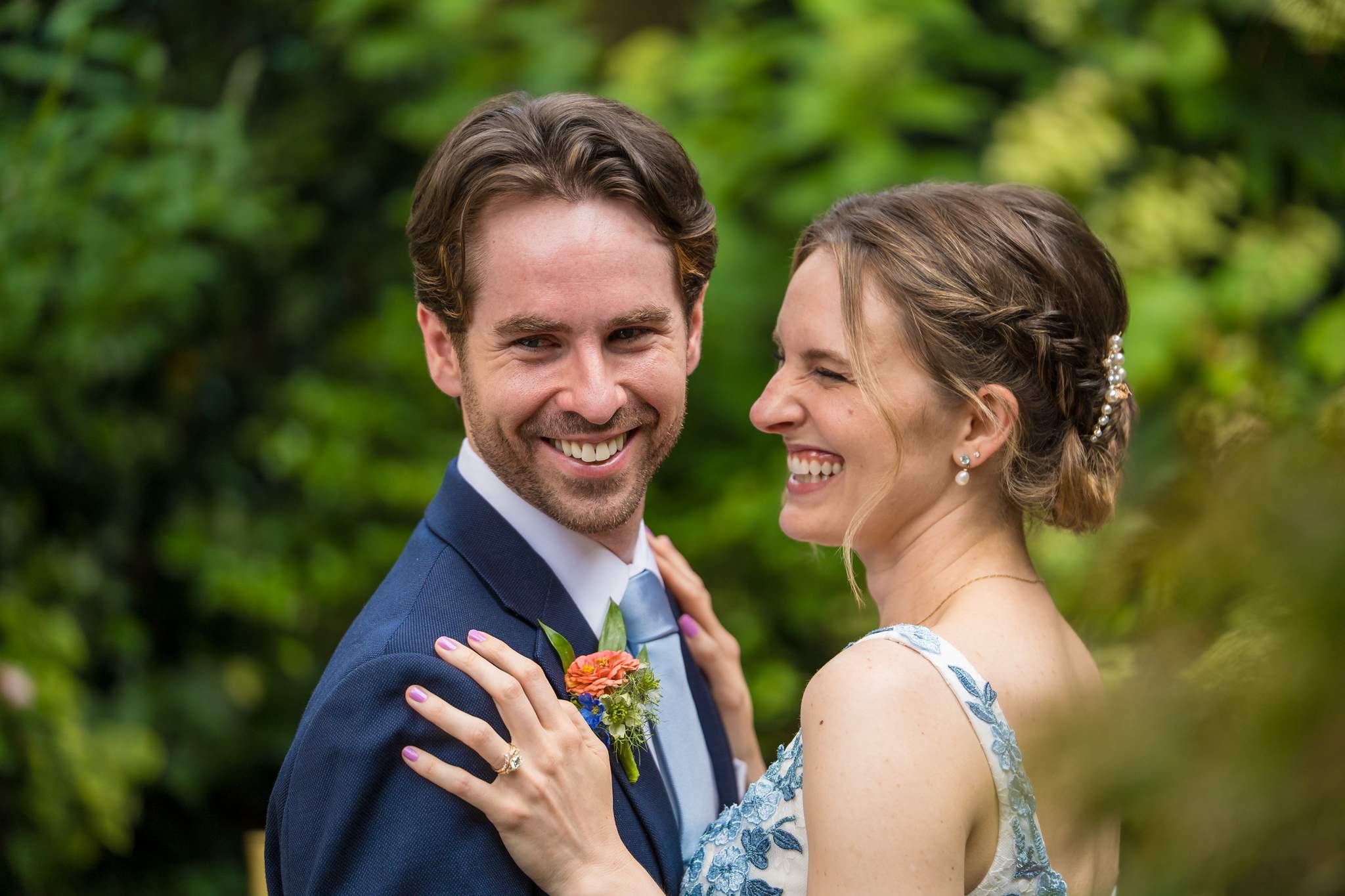 Couple laughing in a close portrait in the Wahoo! Grill garden