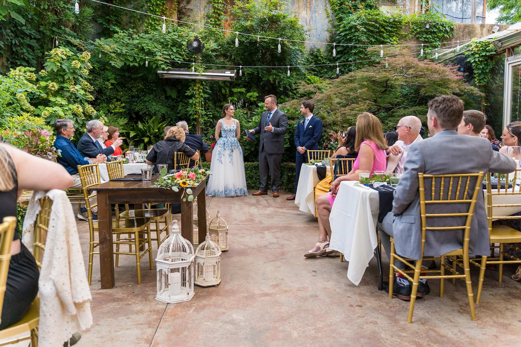 Wide view of a wedding celebration in the Wahoo! Grill garden
