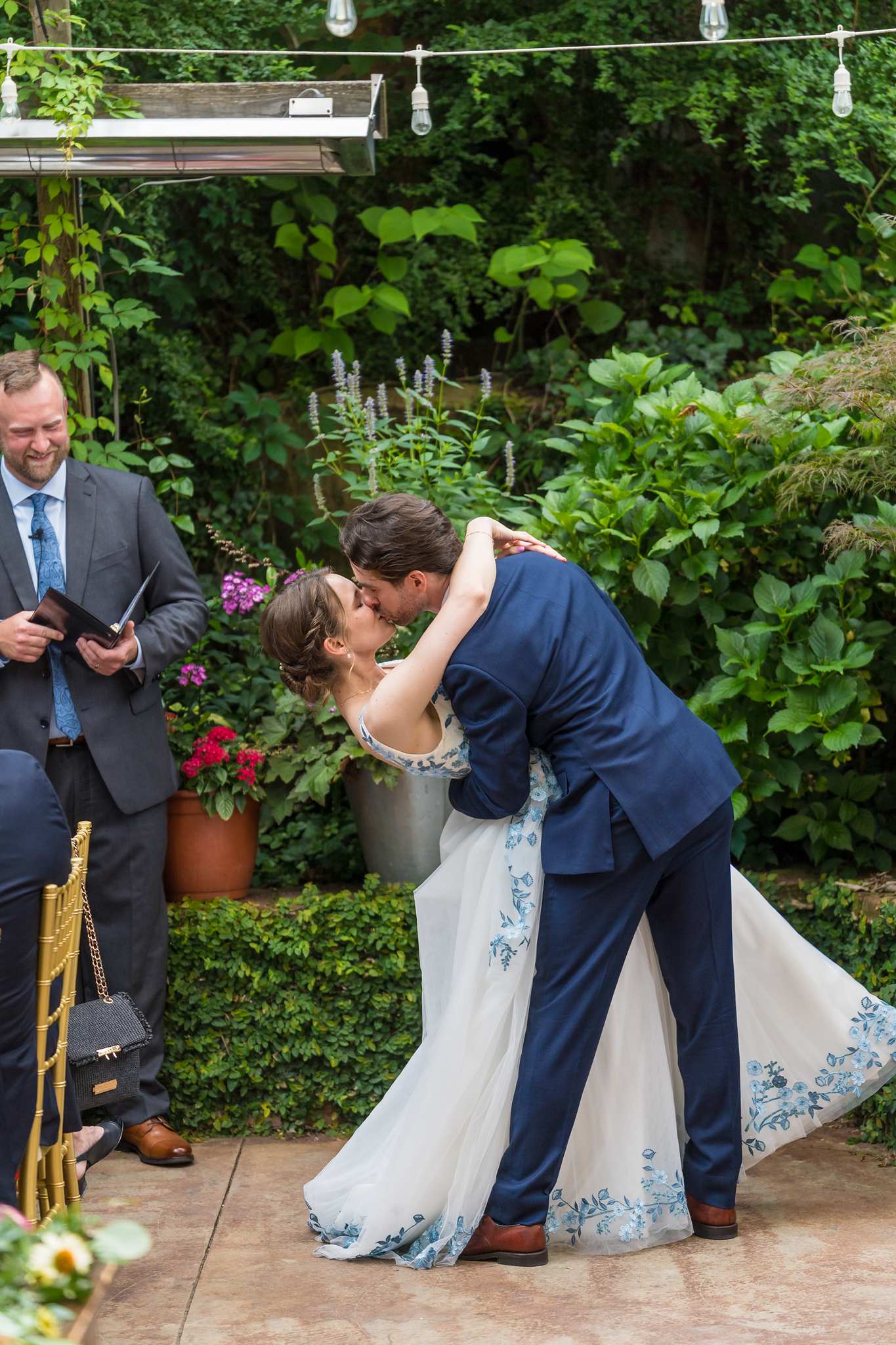 Groom dipping the bride for a kiss in the garden at Wahoo! Grill