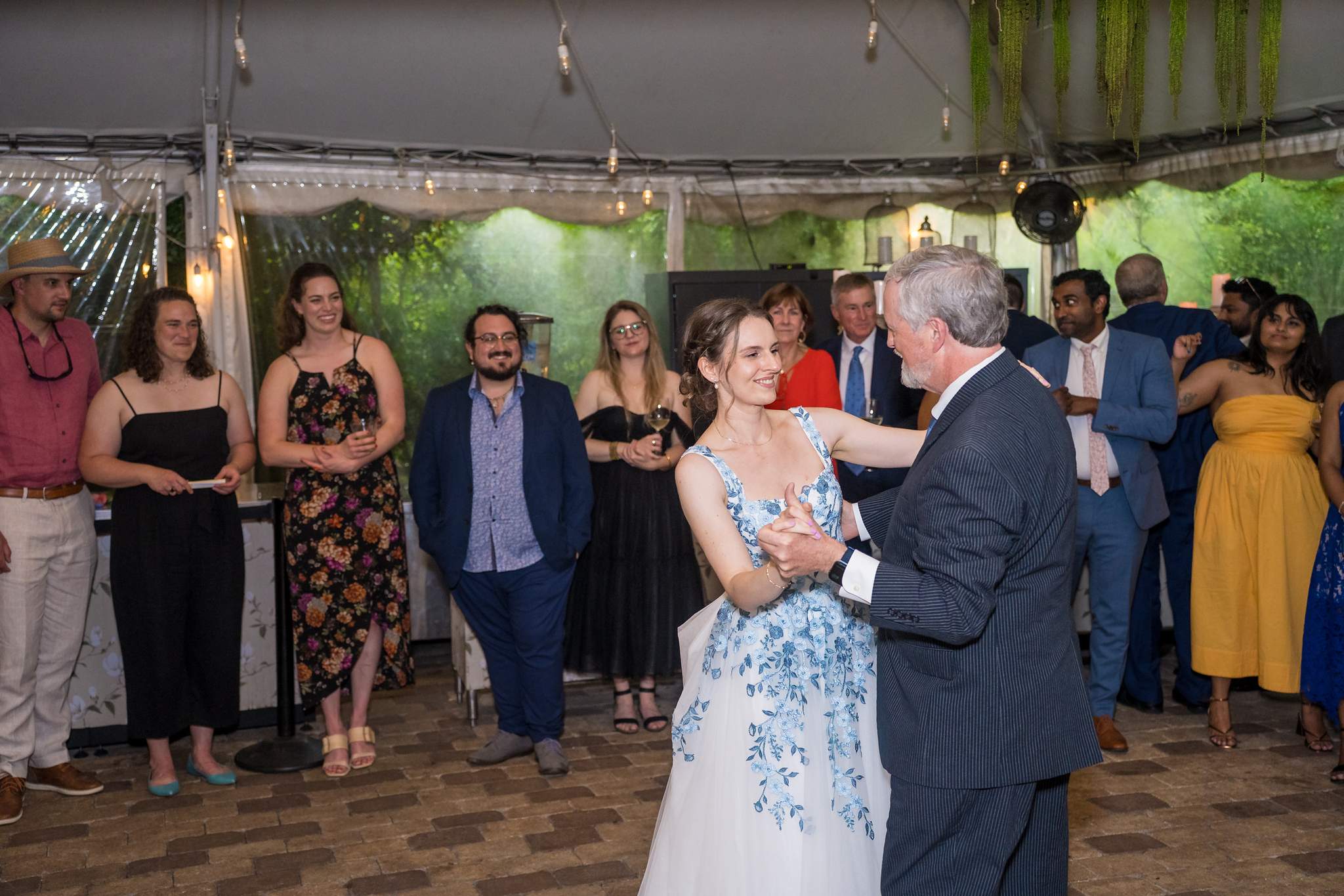 Bride dancing with a family member under the tent at Wahoo! Grill