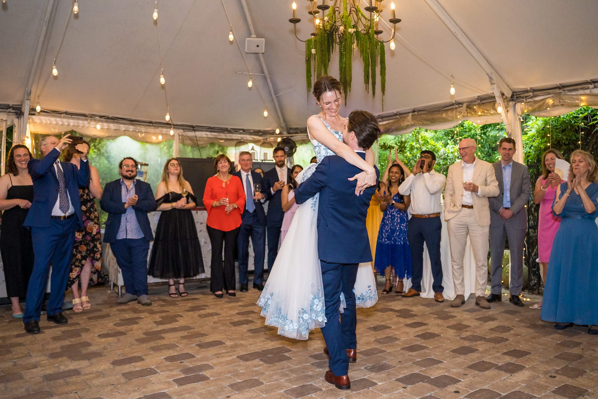 Couple dancing under the tent with chandeliers at Wahoo! Grill