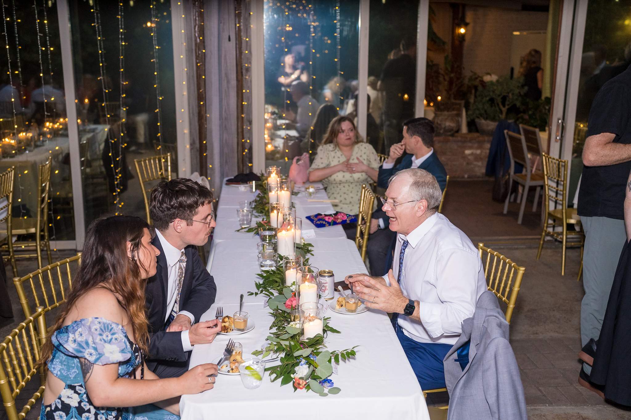 Guests at a long dinner table at a Wahoo! Grill wedding