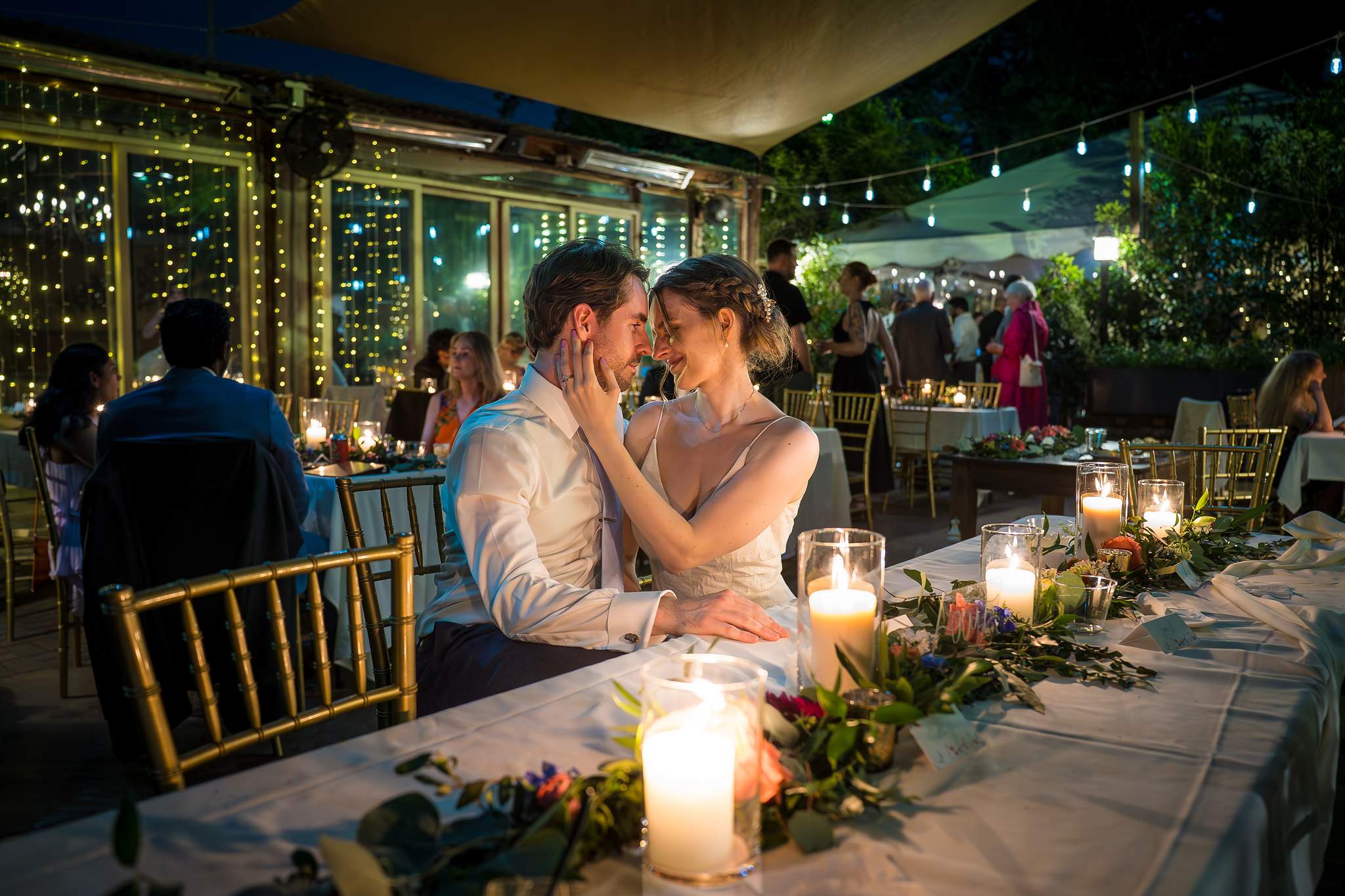 Couple sharing a kiss by candlelight at the end of a Wahoo! Grill wedding