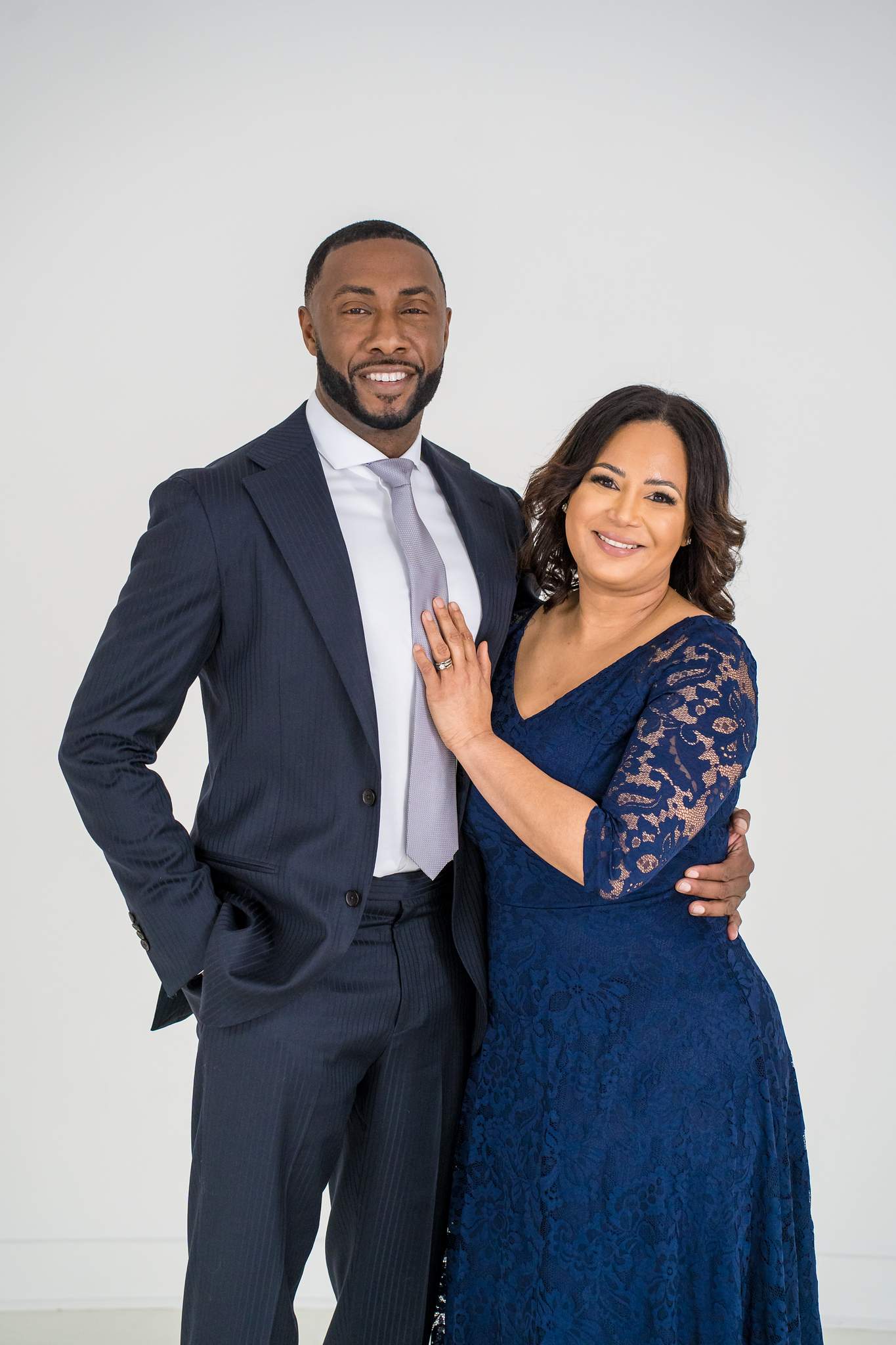 Couple in a navy suit and navy lace dress at White Wall Studio in Woodstock