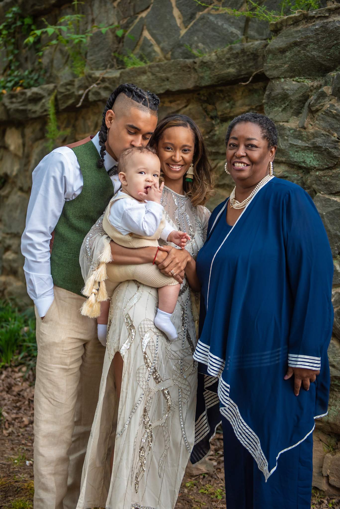 Green vest and white button-down on dad, cream beaded gown on mom, navy tunic on a family member