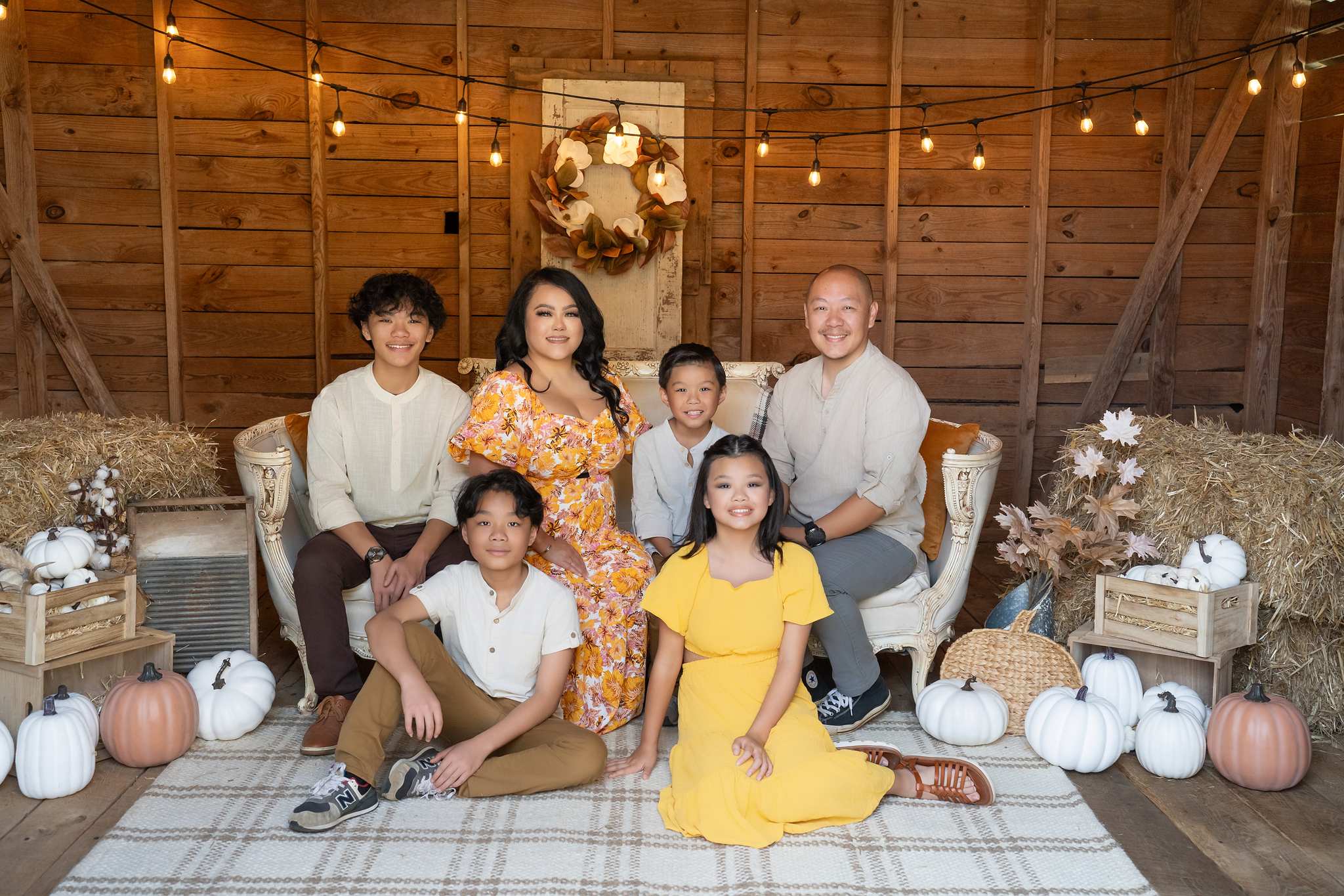 Family on a fall mini session set, mom in orange florals, kids in mustard yellow and cream